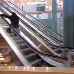 Ride down an escalator in a wheelchair